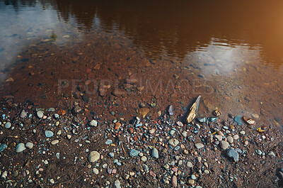 Buy stock photo River bank, water and pebble stones in nature, shoreline and gravel with colourful rocks or sediment in soil. Murky lake, ecosystem and outside ecology for tranquility, landscape and calm stream