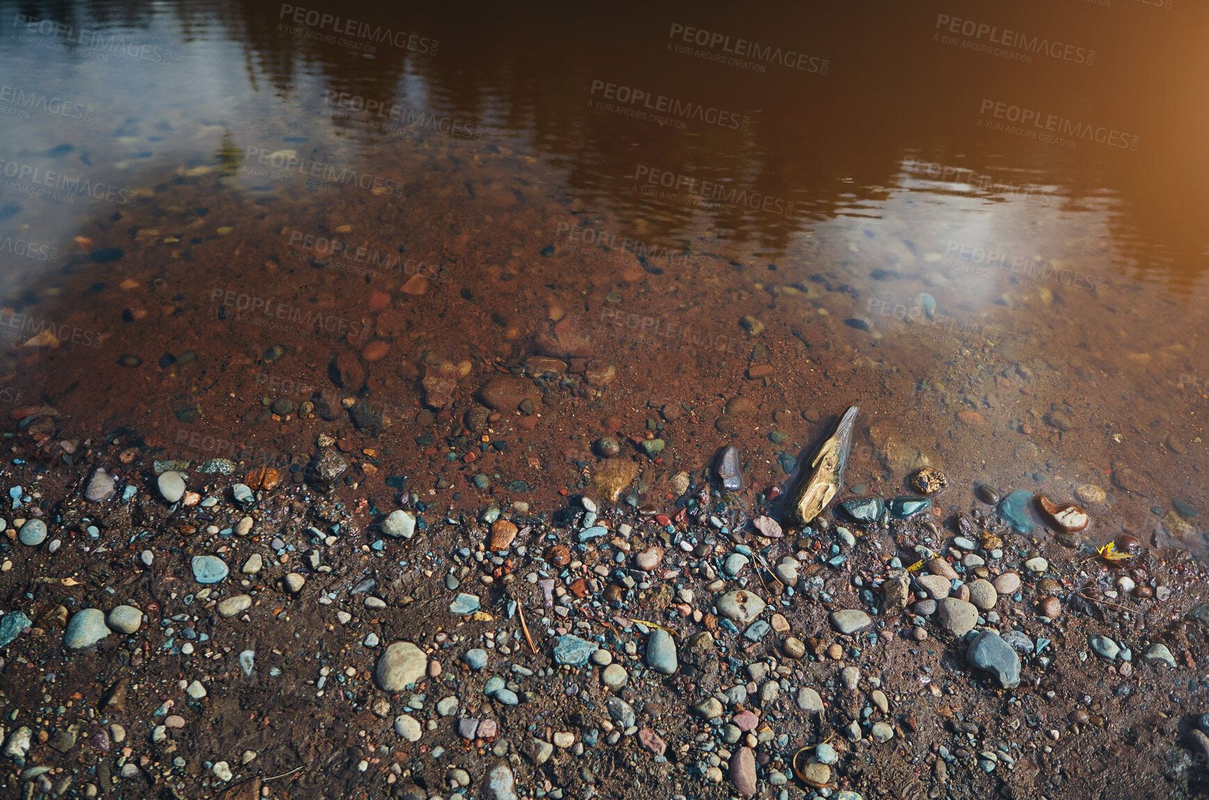 Buy stock photo River bank, water and pebble stones in nature, shoreline and gravel with colourful rocks or sediment in soil. Murky lake, ecosystem and outside ecology for tranquility, landscape and calm stream