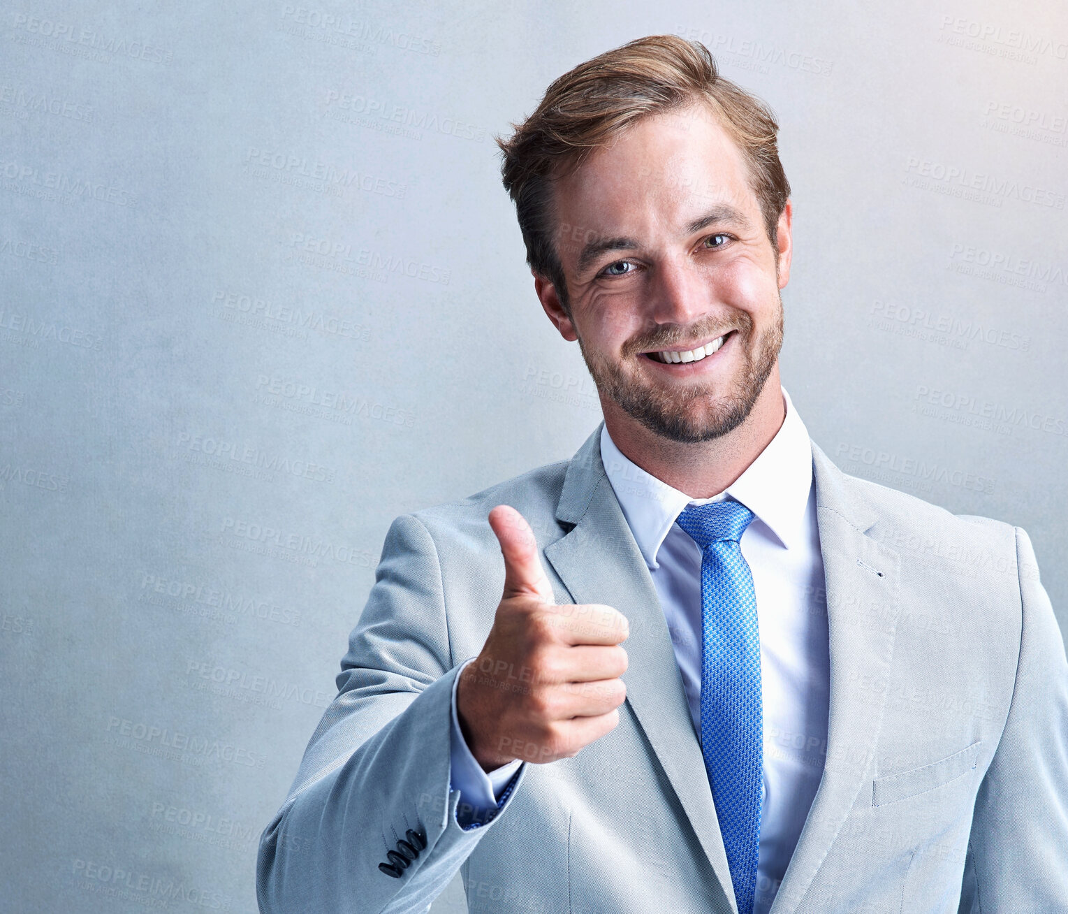 Buy stock photo Businessman, portrait or thumbs up with smile for success, thank you or good job in studio. Lawyer, happy and like approval for support, goals or promotion for achievement on isolated gray background