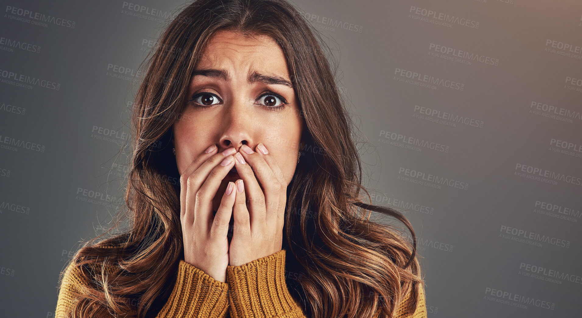 Buy stock photo Portrait, scared and woman with fear, surprise and emotions with secret news on grey studio background. Face, person and model with reaction, shocked and cover mouth with anxiety and emoji of gossip