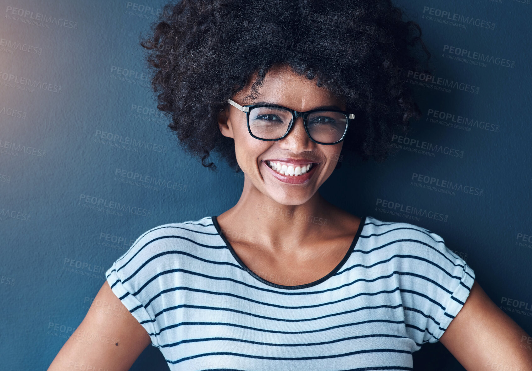 Buy stock photo Portrait, afro and black woman with glasses, fashion and happiness on blue studio background. African person, face and model with eyewear, gen z and casual outfit with smile, stylish clothes and joy