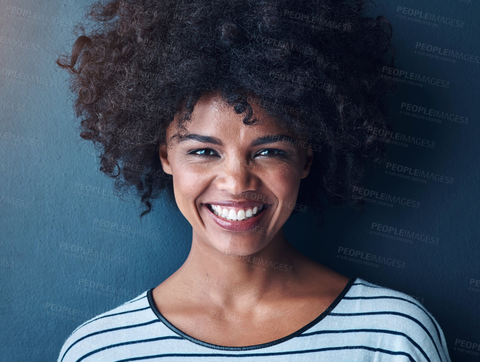 Buy stock photo Black woman, smile and portrait with funny, glow and confident on blue studio background. Girl, face and model with afro laughing for joke, comic and happiness or positive mood with natural beauty