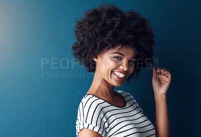 Buy stock photo Woman, portrait and pull afro in studio with mockup space for growth, results or smile by blue background. African person, girl and model with curly hair care, happy and transformation with cosmetics