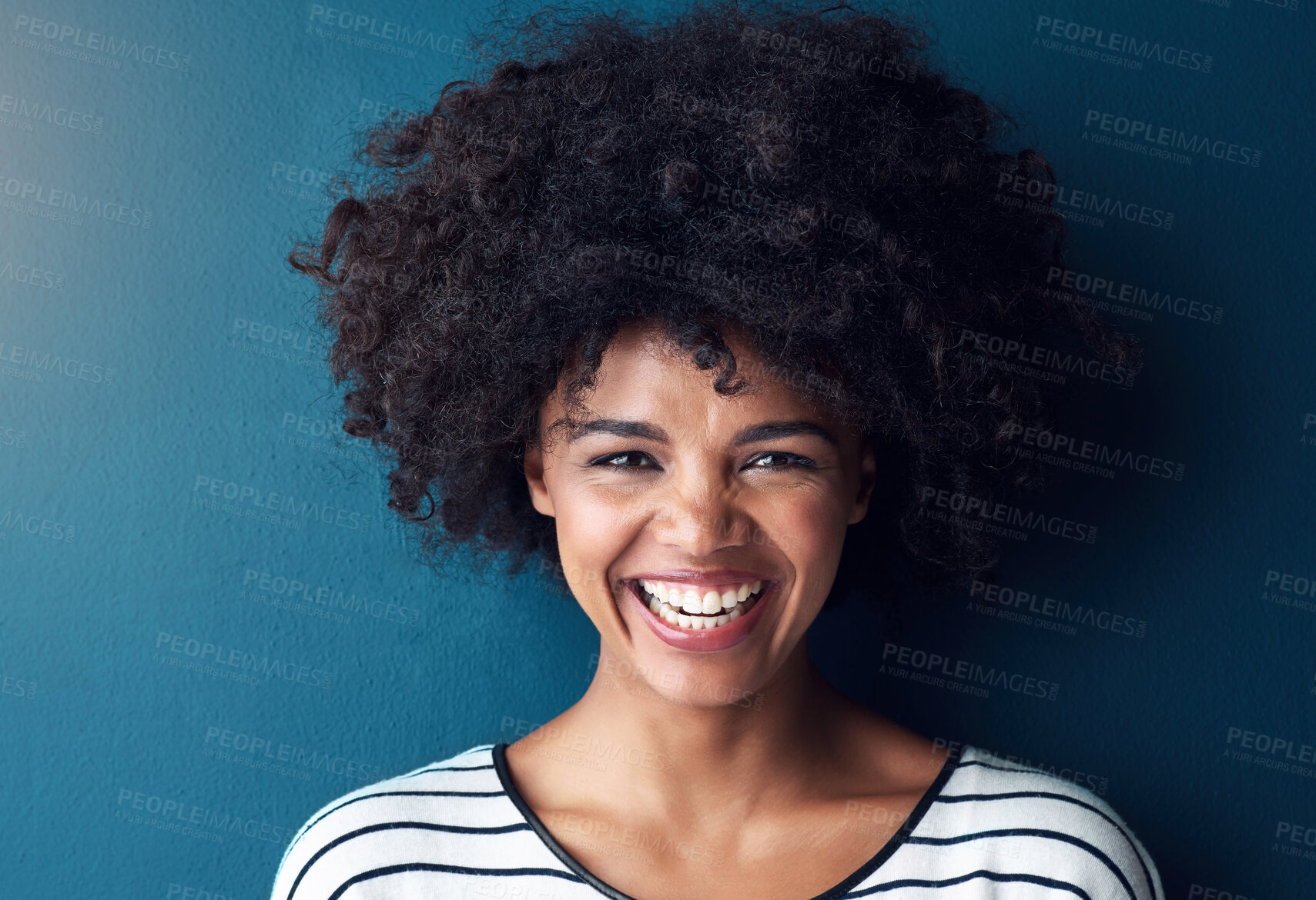 Buy stock photo Black woman, portrait and smile with funny, glow and confident on blue studio background. Girl, face and model with afro laughing for joke, comic and happiness or positive with natural beauty 