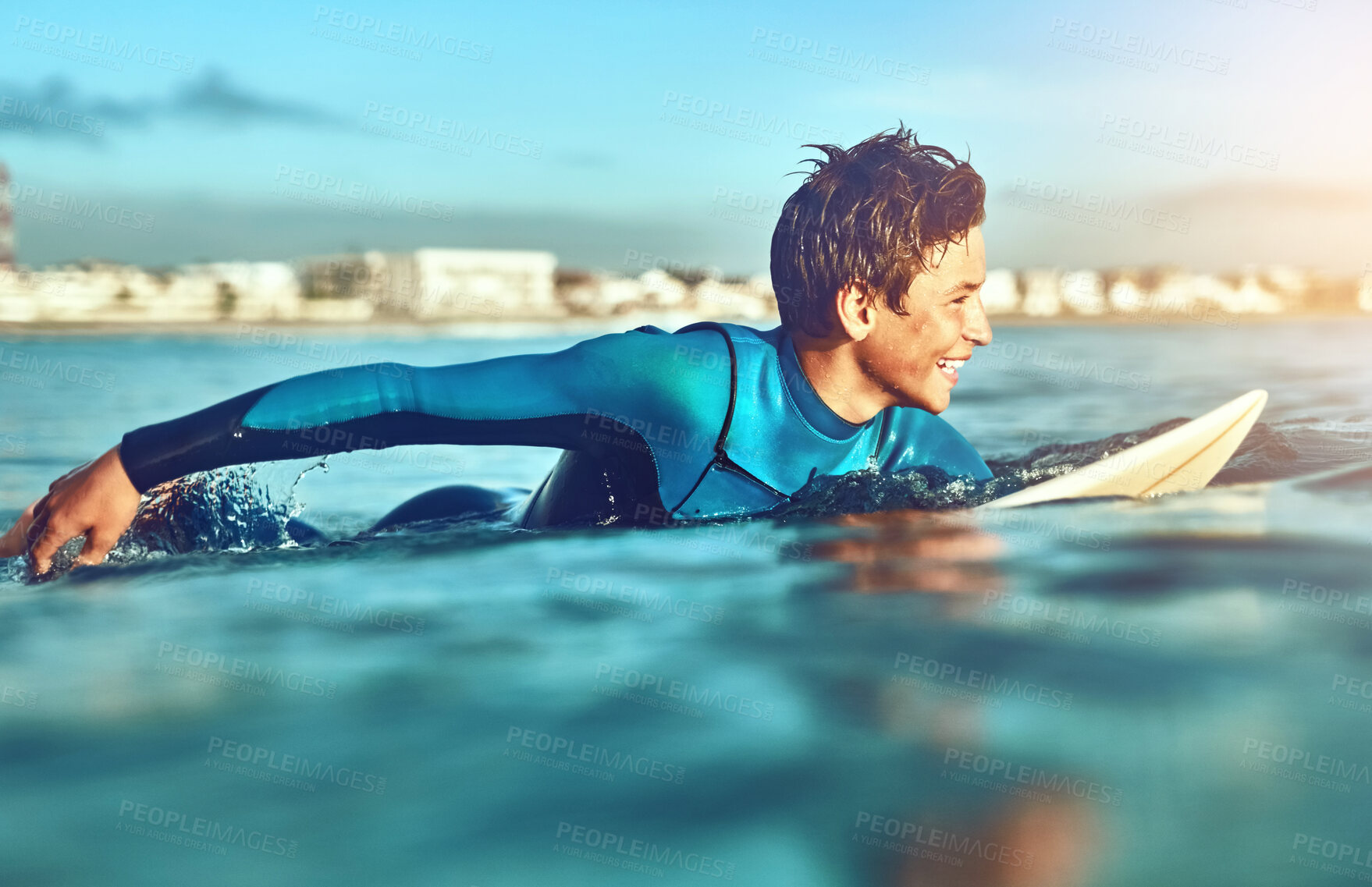 Buy stock photo Teenager, boy and surfing with waves, beach and happiness for fitness, getaway trip and cheerful. Surfer, athlete and vacation with holiday, adventure and sunshine in ocean for sports and excited