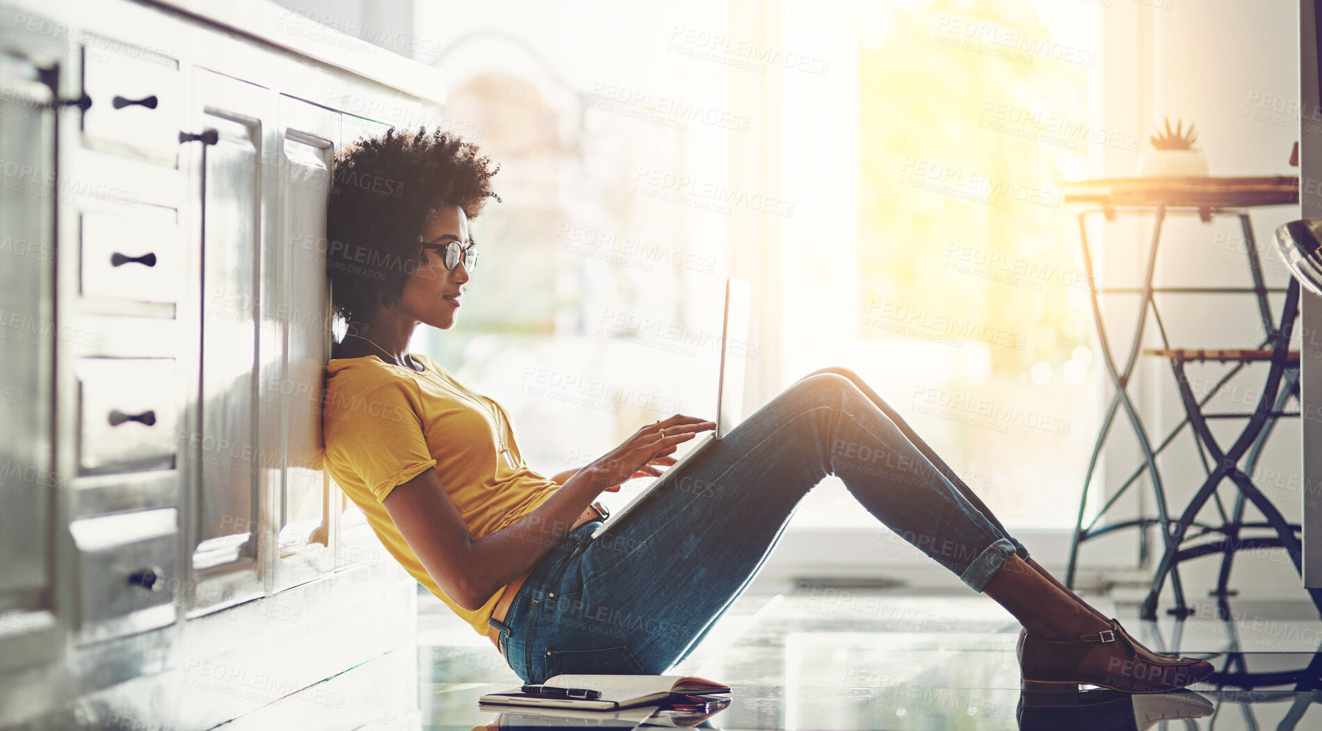 Buy stock photo Black woman, kitchen and relax on floor with laptop for blog update, digital content creation and remote work for freelance job. Girl, home and technology for blogging, writing and email notification