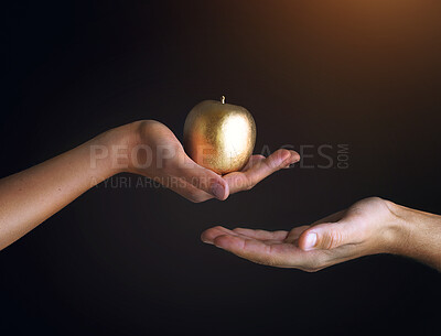 Buy stock photo Gold, apple and hand of people in studio with forbidden fruit, giving and temptation of sin. Creative, art and Christian with colorful food for spiritual, faith and religion on black background