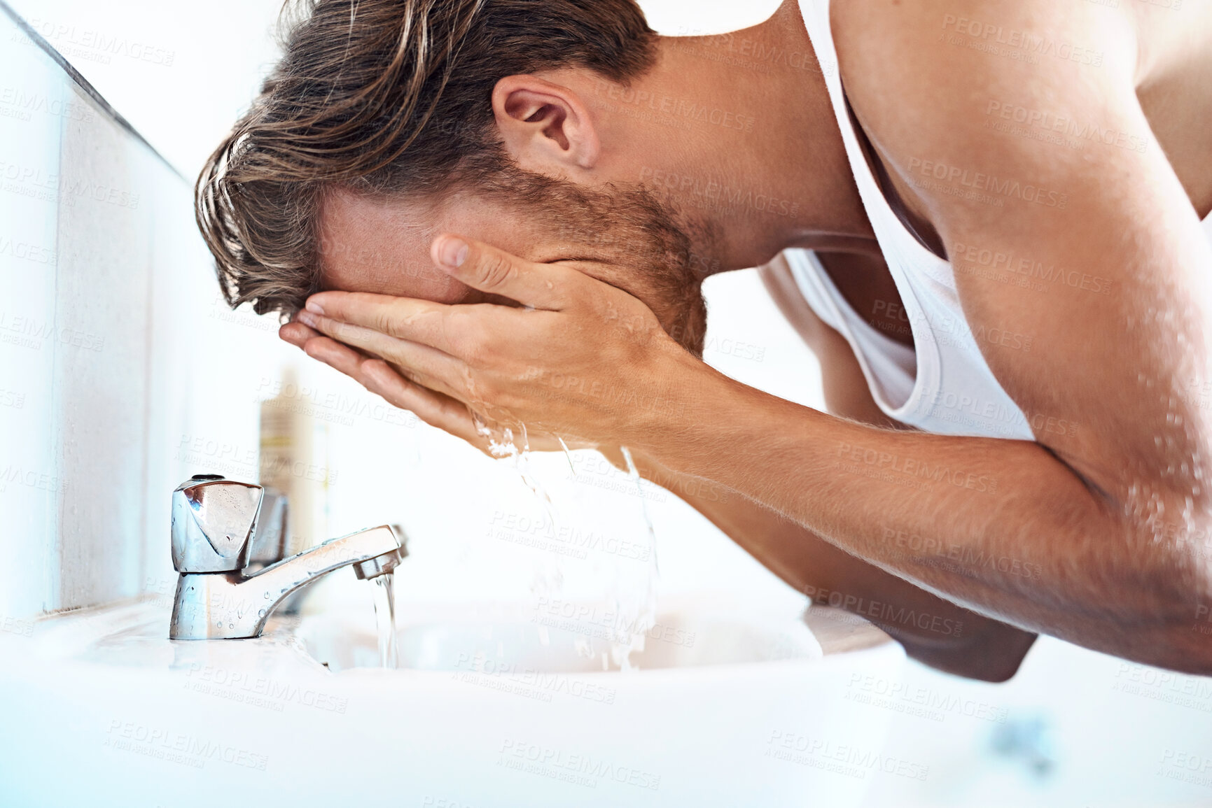 Buy stock photo Water, cleaning and man in bathroom for washing face, hygiene or morning routine at sink. Splash, wellness and male person by faucet for grooming, self care or natural facial treatment in home
