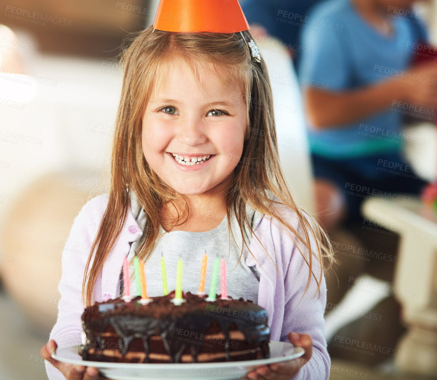 Buy stock photo Happy, portrait and girl child with birthday cake, smile and hat in classroom for event, party or celebration. Dessert, face and excited kid with chocolate, candle or snack at school with friends