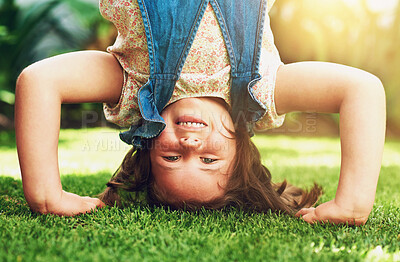 Buy stock photo Garden, portrait and girl with hand stand, playful smile and outdoor fun to relax on summer weekend. Sunshine, energy and happy kid in backyard for playing, adventure and child development on grass