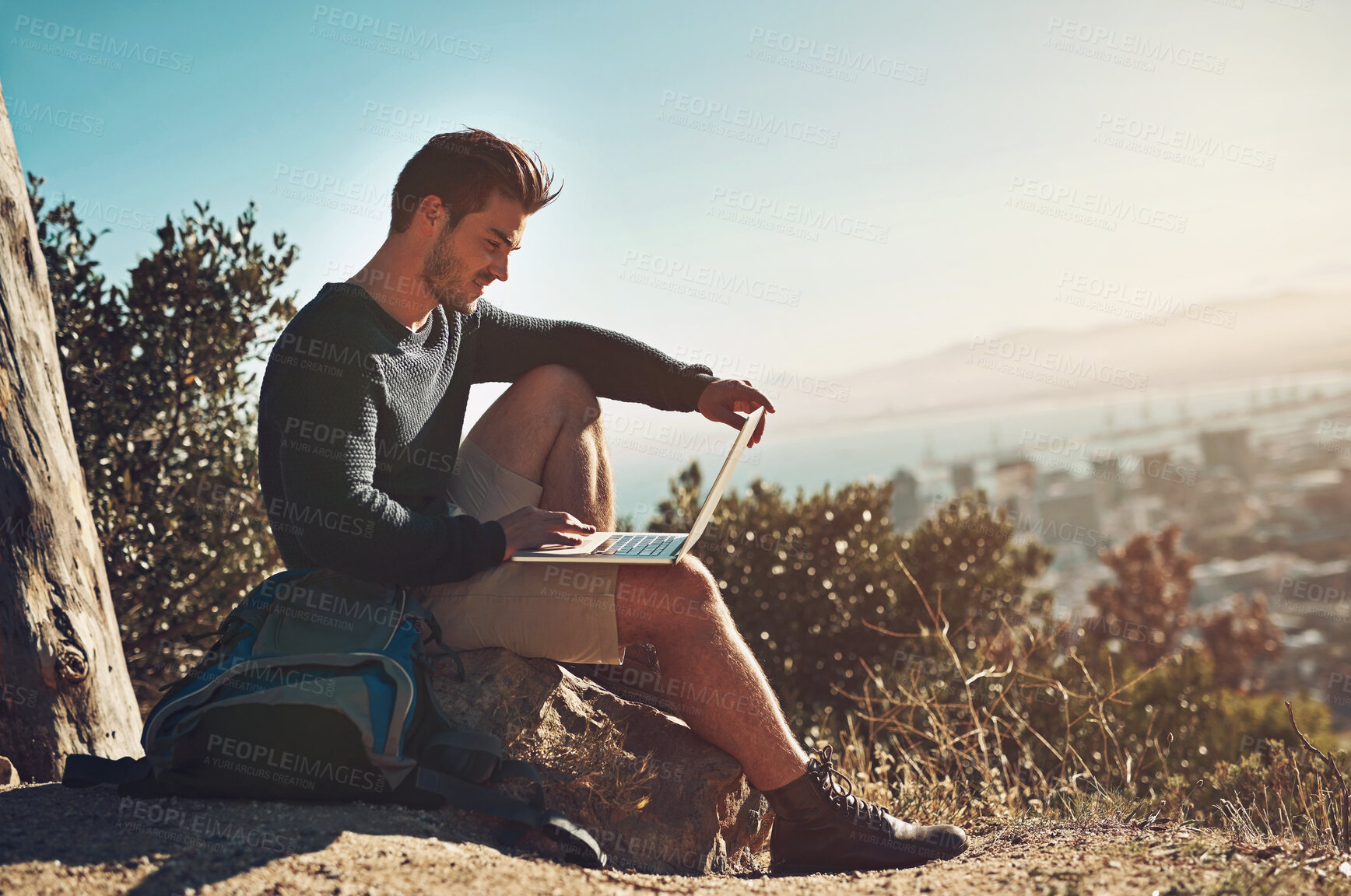 Buy stock photo Happy, man and hiker with laptop outdoor for remote work, connection and map location with scenic view. Male person, freedom and computer in nature for typing, research and adventure blog or website