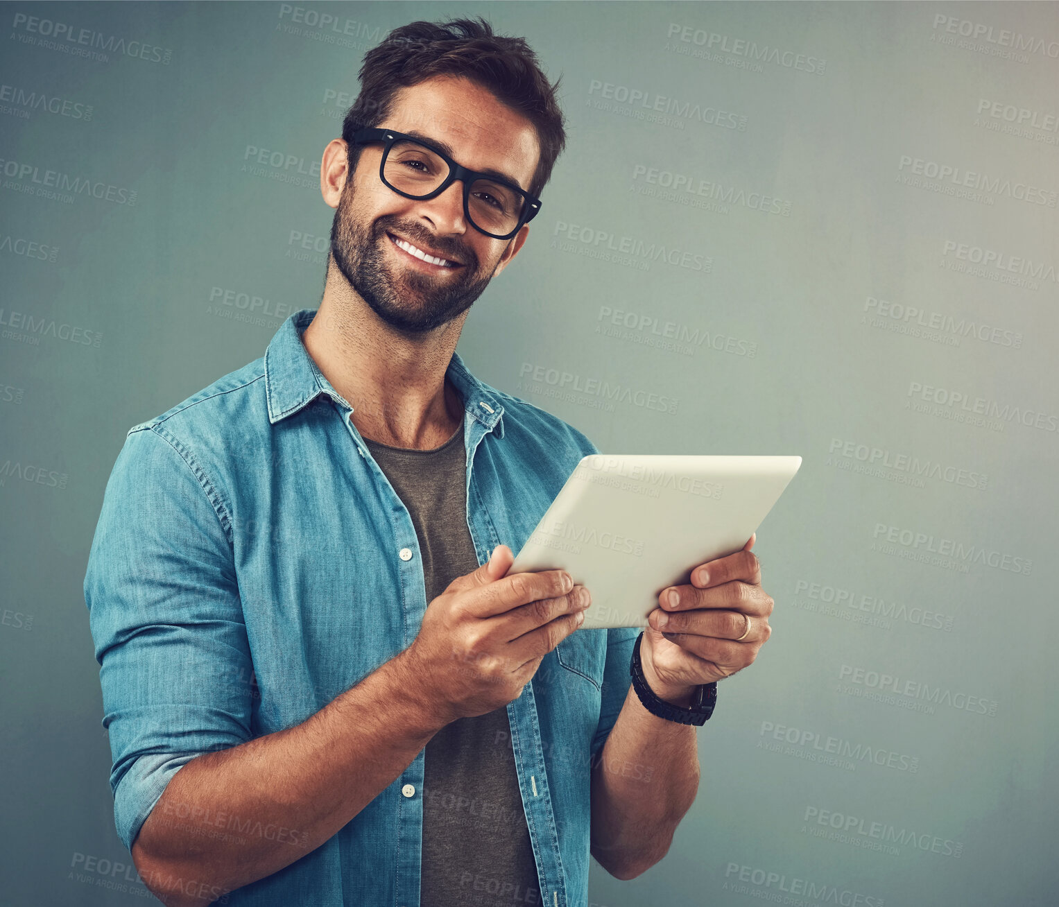 Buy stock photo Man, gray background and portrait with tablet and glasses, career with software programming in London. Male creative, ebook or studio with happiness for digital job, mobile app or website development