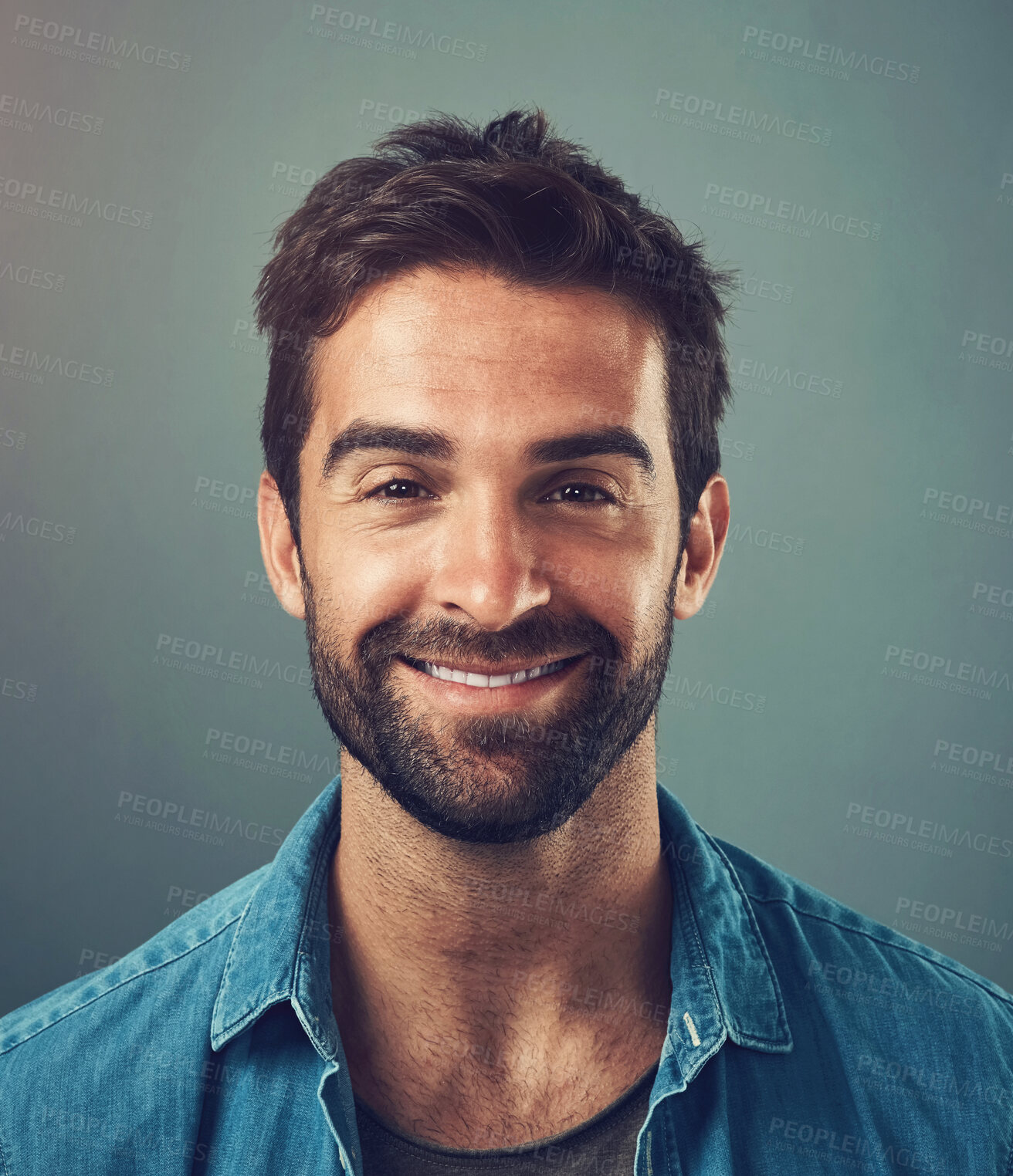 Buy stock photo Happy man, fashion and style in portrait, trendy and cheerful with gray background in studio. Male person, smile and outfit for confidence, retail or sale in advertisement or promotion in denim shirt