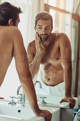 Buy stock photo Beauty, face and beard care with man looking in bathroom mirror during morning routine at home. Skin, health and reflection for guy, grooming and wellness for natural and facial treatment results