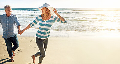 Buy stock photo Happy couple, holding hands and running at sea on vacation, travel or summer holiday for love in nature. Mature man, woman and beach for adventure, funny or laughing on date together outdoor on space