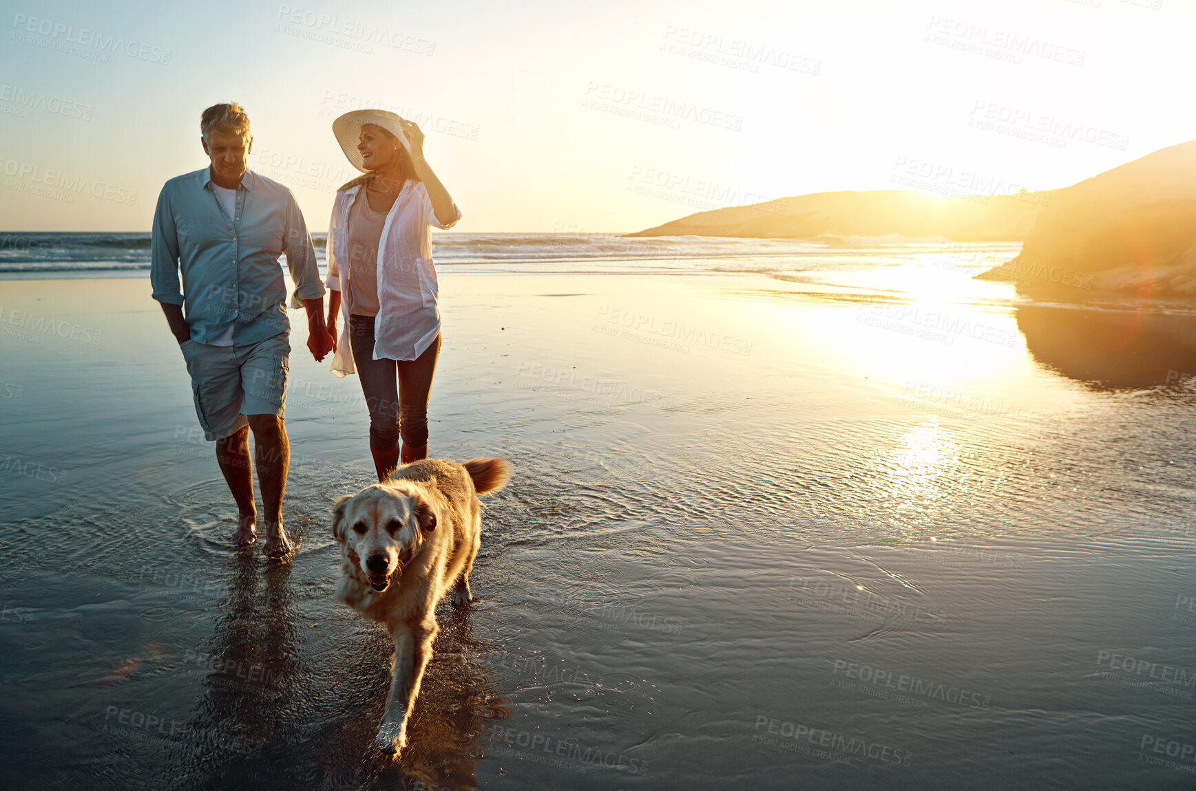 Buy stock photo Beach, water and couple with dog at sunset for outdoor adventure, travel and vacation together. Man, woman and holding hands with furry pet by ocean for love, support and summer holiday in Cancun