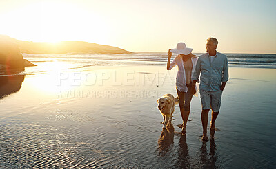 Buy stock photo Senior couple, beach and walking with dog in sunset for romance, love or bonding together in nature. Man, woman or lovers holding hands in outdoor sunshine on water or ocean coast with pet or animal