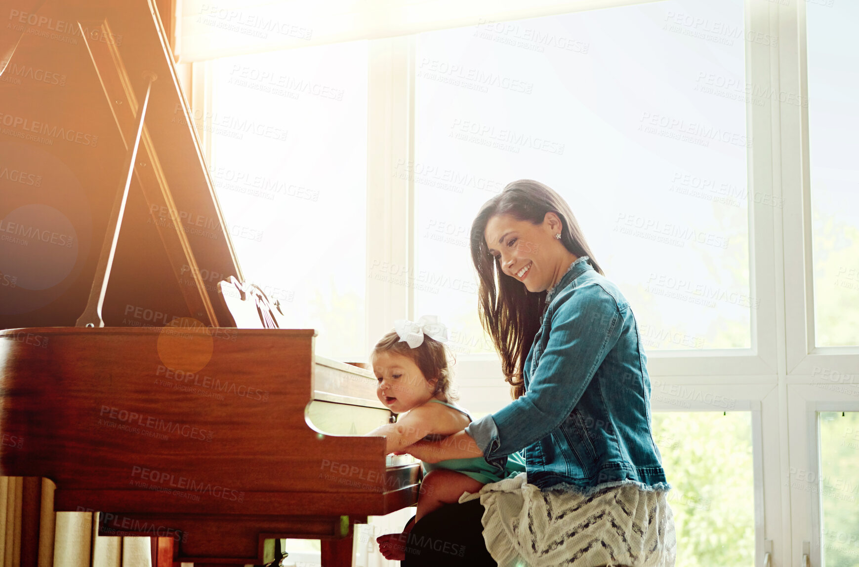 Buy stock photo Happy mother, baby and playing with piano instrument for music, window or fun bonding at home. Mom with daughter, child or kid on musical equipment with smile for sound, tune or talent at house