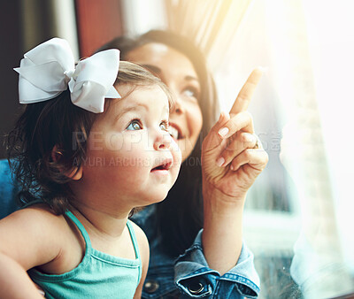 Buy stock photo Mother, baby and happy or home window, love and bonding with family in apartment together with girl toddler. Childhood development, growth and smile or caring, woman and hand pointing in house