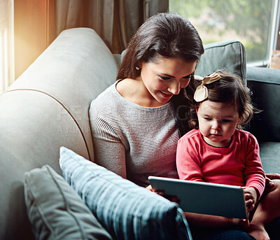 Buy stock photo Education, mother and child with tablet on sofa together for internet connection and development in home. Woman, kid or daughter with tech on couch for online learning and studying with love 