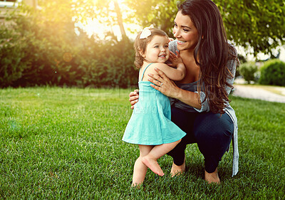 Buy stock photo Mom, girl and hug on lawn in garden with smile, care and connection with love in summer at family home. Embrace, mother and daughter child with play, happy and outdoor on grass in backyard at house