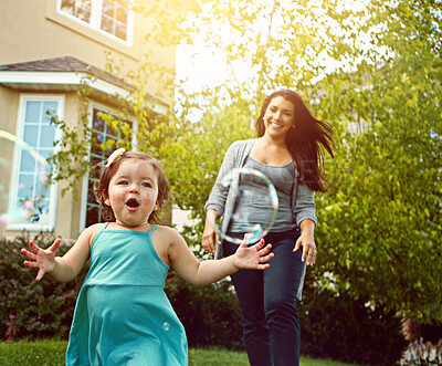 Buy stock photo Mother, child and running with playing in garden for fun activity, bonding and smile outdoor in home. Happy family, woman and daughter on grass with care, explore and bokeh with lens flare in nature