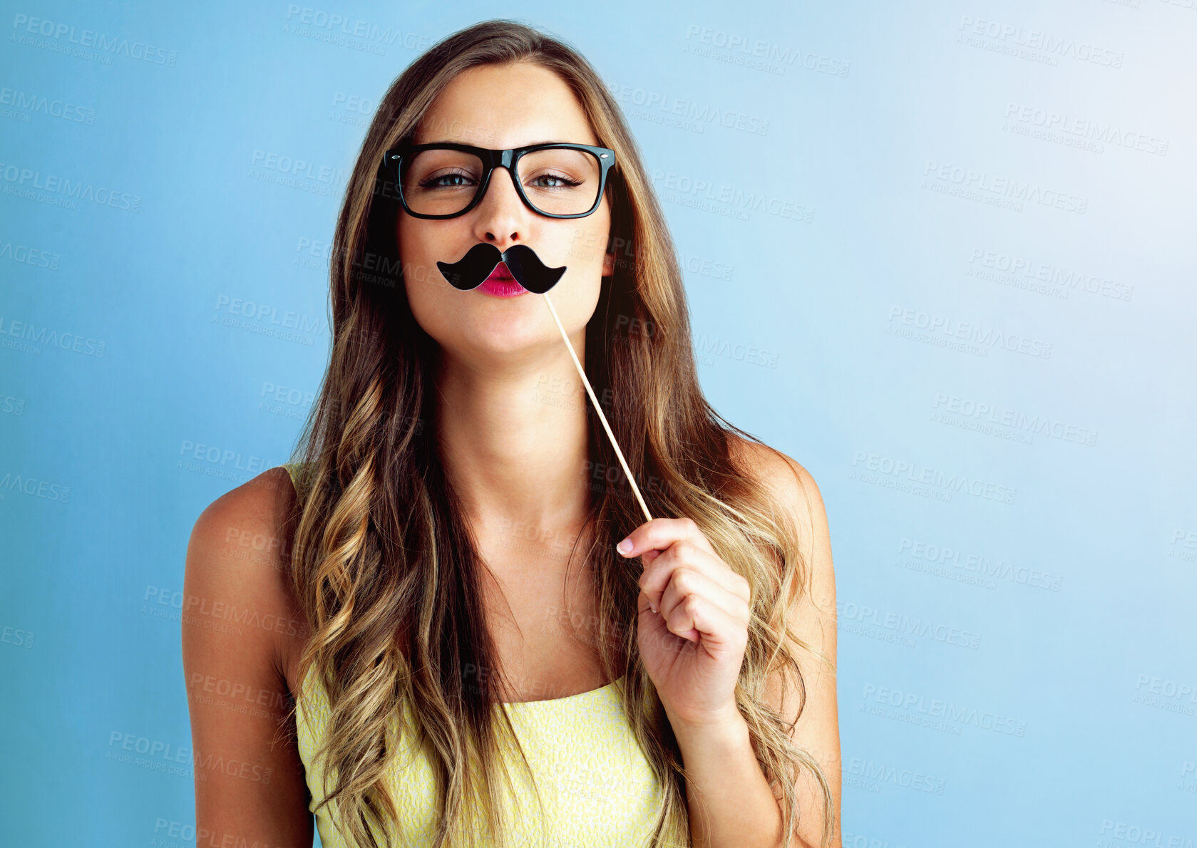 Buy stock photo Girl, moustache and portrait or prop in studio with pout, photo booth and comic icon with mockup space. Woman, person and funny face with cardboard on stick for celebration and fun on blue background