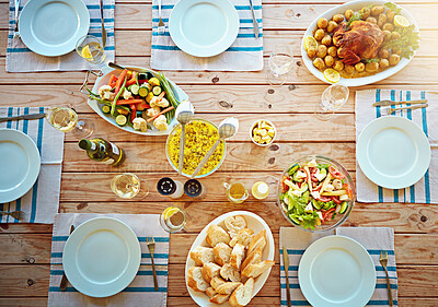 Buy stock photo Food, lunch and above with thanksgiving, vegetables and healthy meal at dinner table with plates. Brunch, drinks and nutrition with feast for gathering in dining room at home with salad and bread