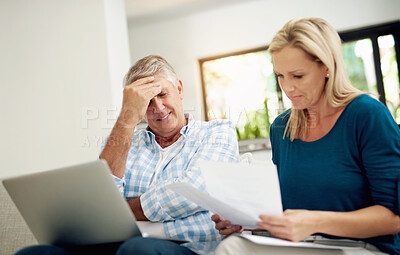 Buy stock photo Mature, couple and home with laptop or documents, stressed man and woman planning for financial expenses. Bills, paperwork and online for tax review or budget, insurance contact and sofa in lounge