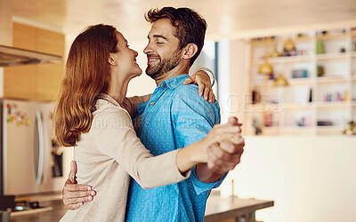 Buy stock photo Happy couple, dancing and together in kitchen for wellness, happiness for anniversary or date. Man, woman and movement in home with support and music, partners with commitment and hug or smile