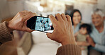 Phone screen, hands and picture of family in living room with smile, kids and grandparent on sofa. Social media, photo and mother with a baby and grandmother happy in a home together with love