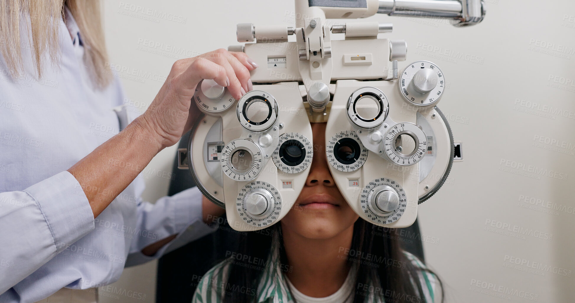 Buy stock photo Eye care, medical and child in clinic, patient and hand of specialist, phoropter or refractor for girl. Healthcare, technology and machine for help for kid, exam and vision for check up in hospital