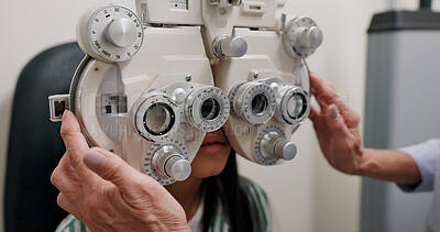 Eye care, machine and child in clinic, test and hand of specialist, phoropter or refractor for girl. Healthcare, technology and medical help for kid, exam and vision for check up in hospital