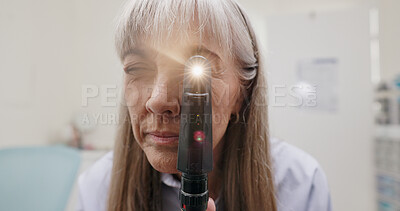 Optometrist, light and ophthalmoscope in clinic for eye exam, eye care and vision. Specialist, woman and testing tools in workplace for eyesight, healthcare and prescription for glaucoma or disease