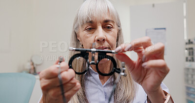 Buy stock photo Mature woman, optometrist and glasses for eye lens or equipment for examination and vision testing. Closeup, tools and trial for diagnosis or eyesight with assessment, consultation or check with care