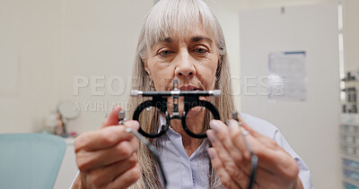 Buy stock photo Mature woman, optometrist and lens for eye care or equipment for examination and vision testing. Closeup, tools and trial for diagnosis, frame and eyesight with assessment, consultation and assist