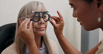 Optometry, optician and woman with trial lens for eye exam, health and wellness in optical store. Ophthalmology, vision and optometrist with senior female patient with prescription testing in shop.