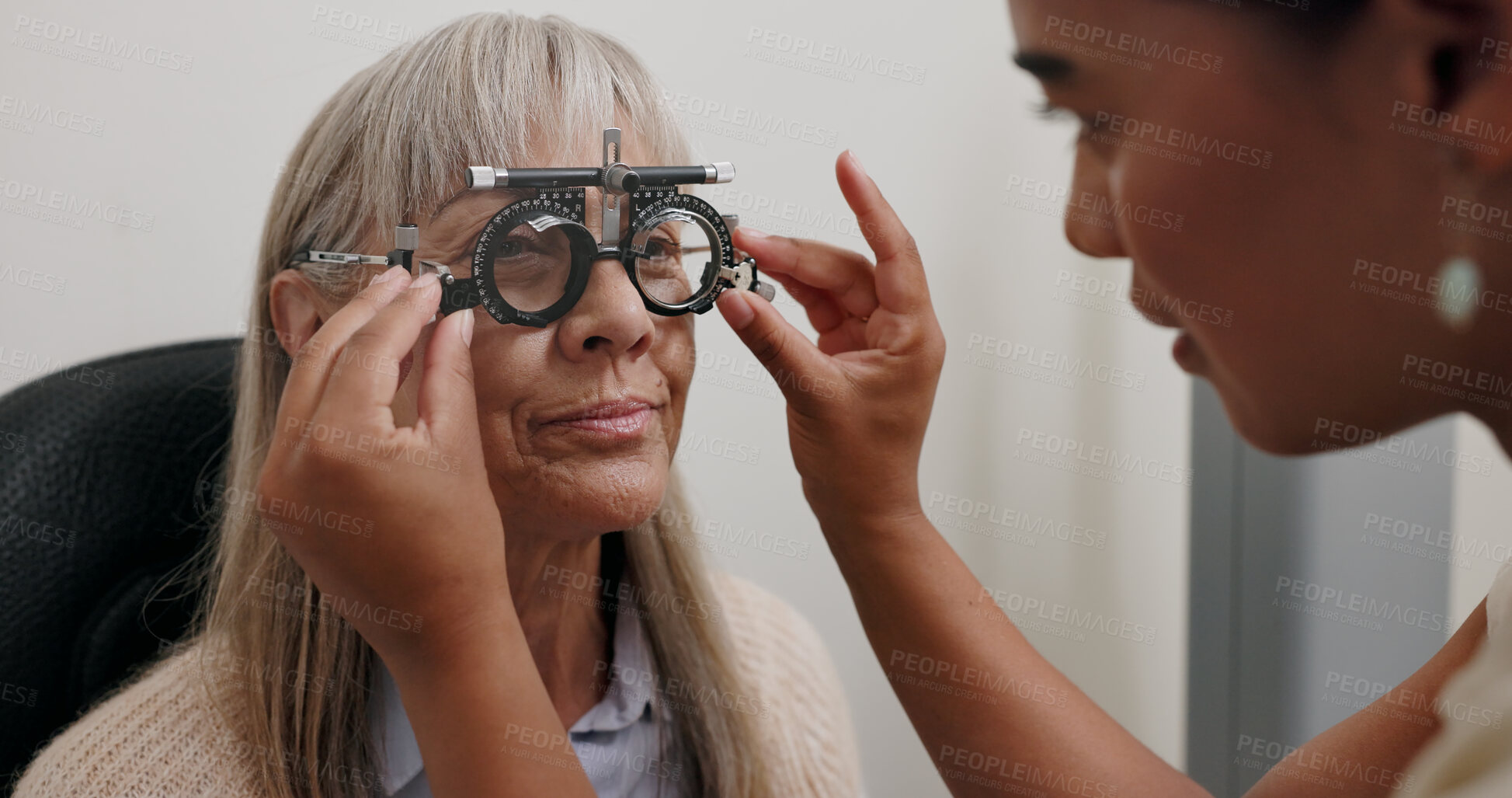 Buy stock photo Women, optometrist and patient with trial lens for eye exam, vision test and prescription fro glasses at store. Doctor, consultation and equipment with assessment for eyesight, care and support