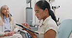 Optometrist, office and woman with tablet in consultation with patient at doctor for eye exam on insurance. Optometry, technology and patient trust results or advice from specialist in healthcare
