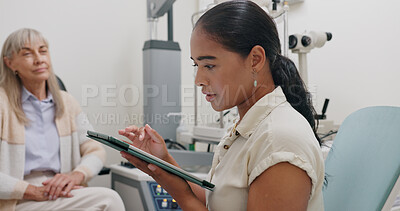 Optometrist, office and woman with tablet in consultation with patient at doctor for eye exam on insurance. Optometry, technology and patient trust results or advice from specialist in healthcare
