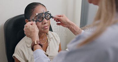 Ophthalmology, hands and woman with trial lens for eye exam, health and wellness in optical store. Optometry, vision and optician with female patient with prescription testing at consultation in shop.