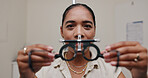 Female optometrist, phoropter and eye exam with glasses for vision and medical care. Woman optician, equipment and product test for eyesight with help from doctor for insurance with motion blur