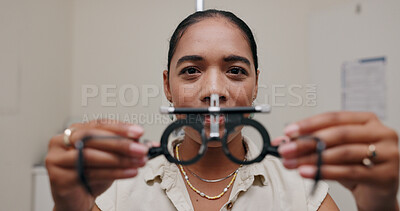 Female optometrist, phoropter and eye exam with glasses for vision and medical care. Woman optician, equipment and product test for eyesight with help from doctor for insurance with motion blur