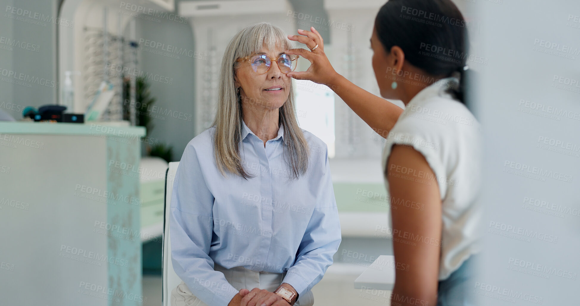 Buy stock photo Mature woman, optometrist and glasses retail for shopping consultation for frame size, assessment or prescription. Female person, eye care and sight store with optician advice, spectacles or lens