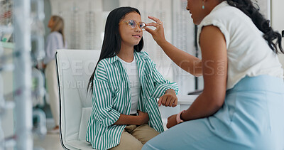 Girl, optometrist and glasses with eye care for customer, sight or vision at optometry store or shop. Woman or optician helping little child, kid or customer with spectacles for size or prescription