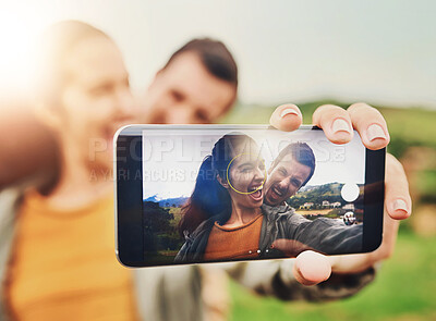 Buy stock photo Hand, screen and selfie of couple for fun, crazy and funny face on phone in countryside. Happy man, woman and vacation on farm with photography, social media update and good memories on holiday