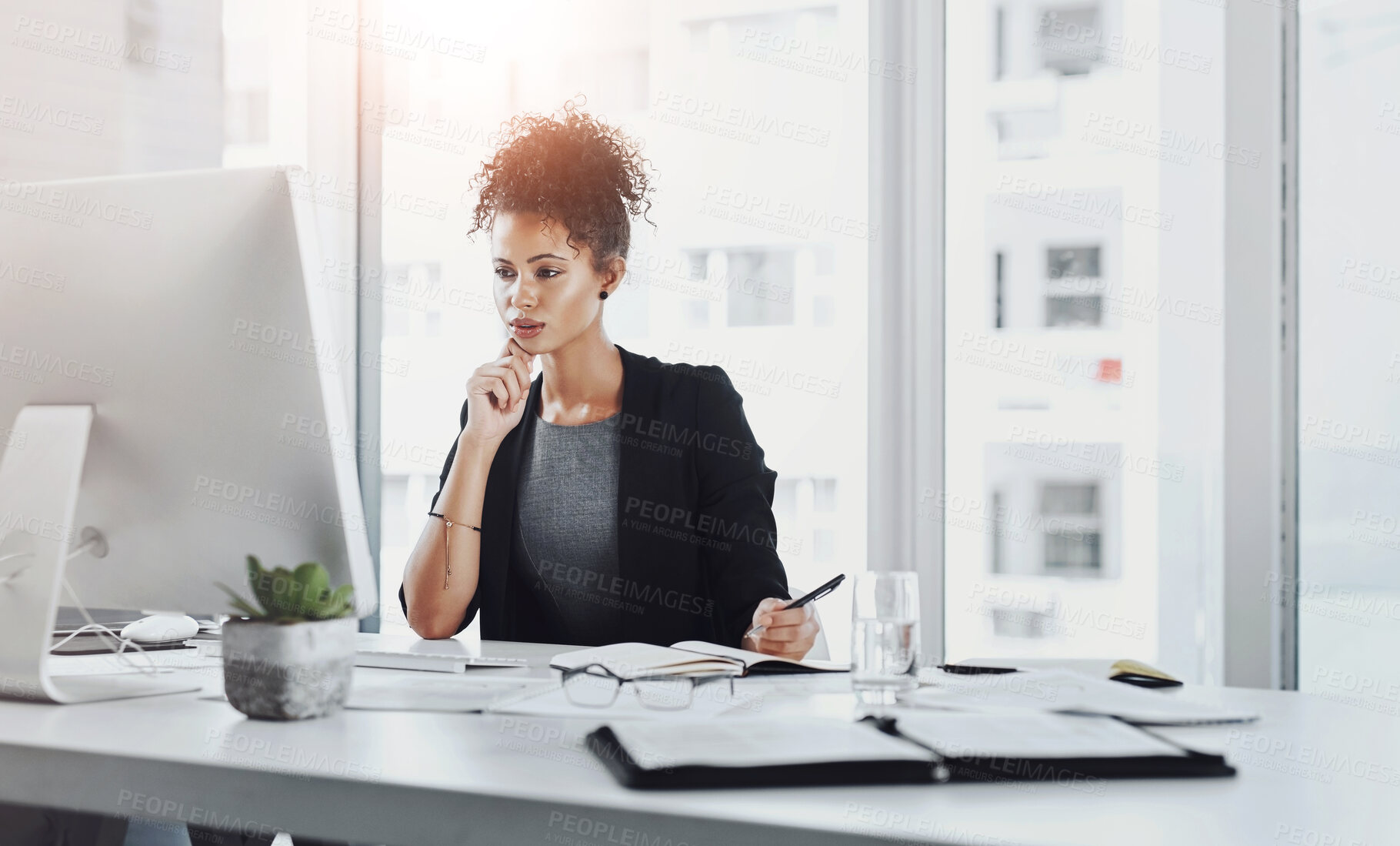 Buy stock photo Serious, reading and woman in office, computer and notes for research, ideas and journalist on desk. Thinking, digital and reporter with notebook for editing of story for blog, news and writing