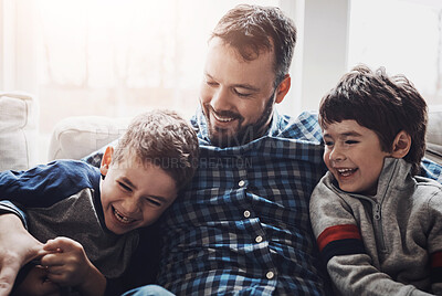 Buy stock photo Playing, happy and father with children on sofa for bonding, loving relationship and relax together in home. Family, morning and dad with kids hug for affection, embrace and smile in living room