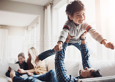 Buy stock photo Father, boy and airplane on sofa with family, smile and bonding with love, joke and funny memory in living room. Mother, dad and kids with games, happy and connection for flight on couch in apartment