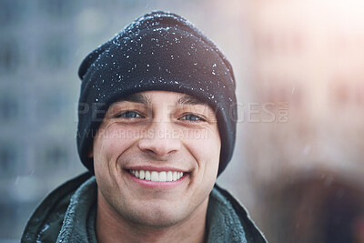 Buy stock photo Man, portrait smile and beanie with snow for cold weather, wellness and travel for holiday break. Male person, hat and happy for winter season with blizzard, ethical fabric and vacation in New York